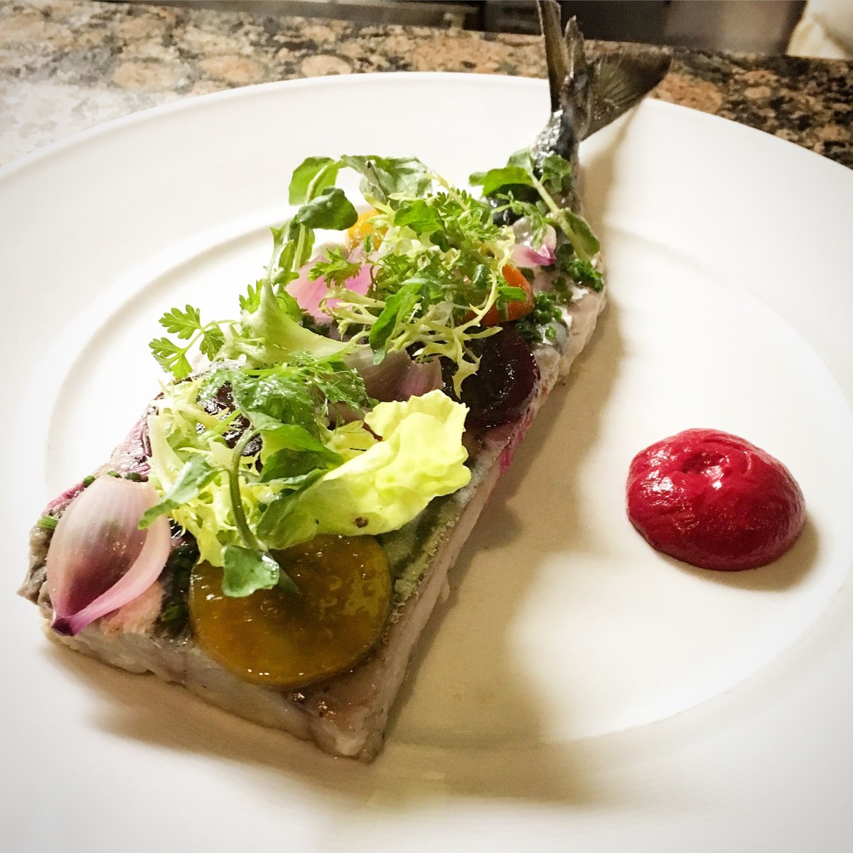 Mackerel with colorful pickled vegetables and fresh herbs at Fleurie